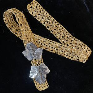 A 1970s GOLD METAL WEAVE BELT WITH RHODIUM LEAF BUCKLE