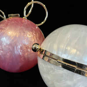A PERSPEX ORBIT BAG WITH GOLD FITTINGS