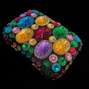 AN EVENING CLUTCH WITH MULTICOLOURED PLASTIC JEWELS.