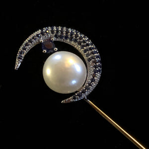 A CRESCENT MOON AND PEARL TIE PIN